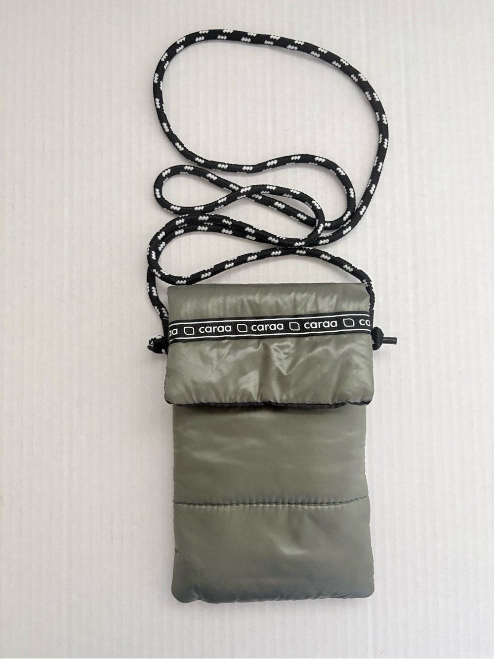 Caraa Olive Green Puffer Crossbody Phone Pouch with Black & white Rope Strap.